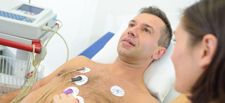 Man having heart monitor attached